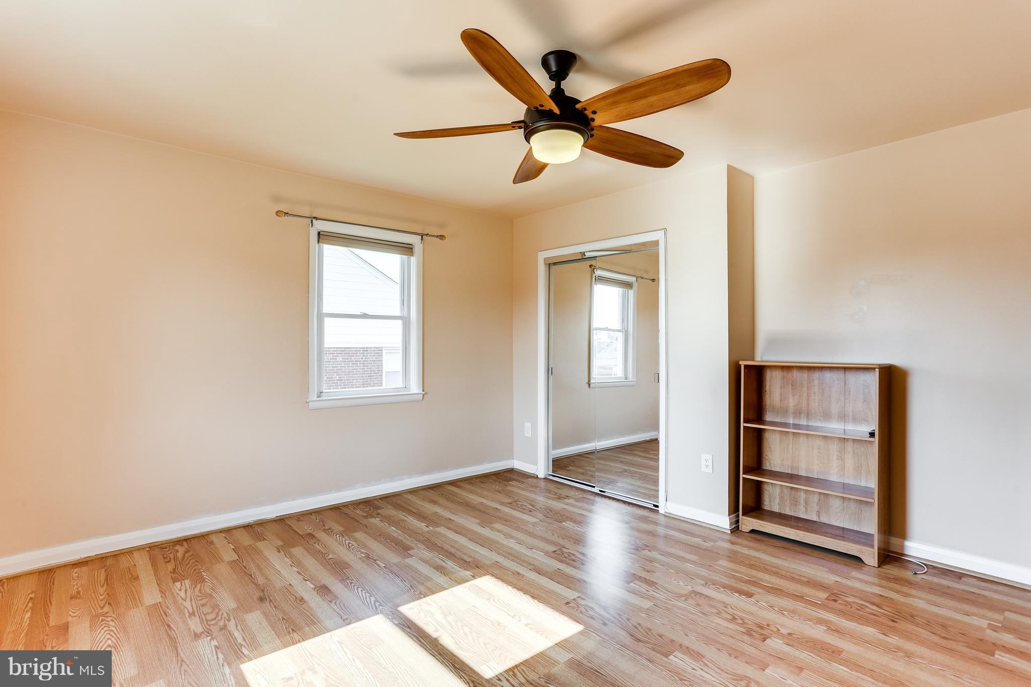 6117 Edlynne Road Baltimore, MD 21239 - Photo 13 of 18 wooden floor in an empty room with a window