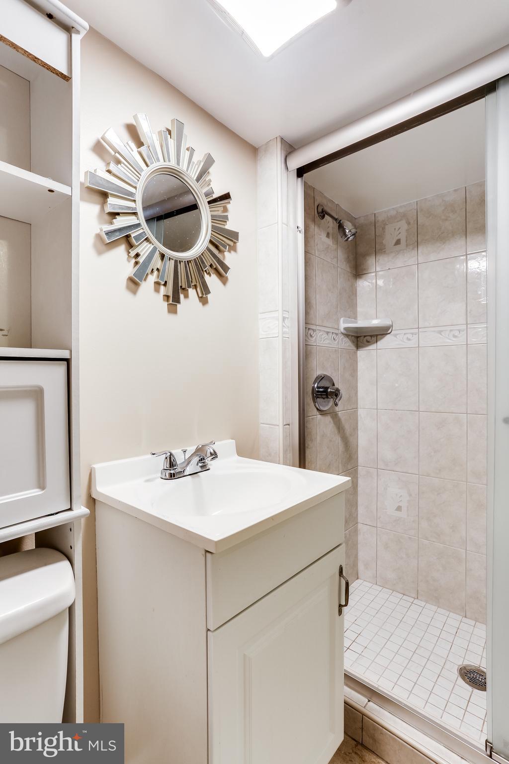 6117 Edlynne Road Baltimore, MD 21239 - Photo 16 of 18 a bathroom with a sink a toilet and shower