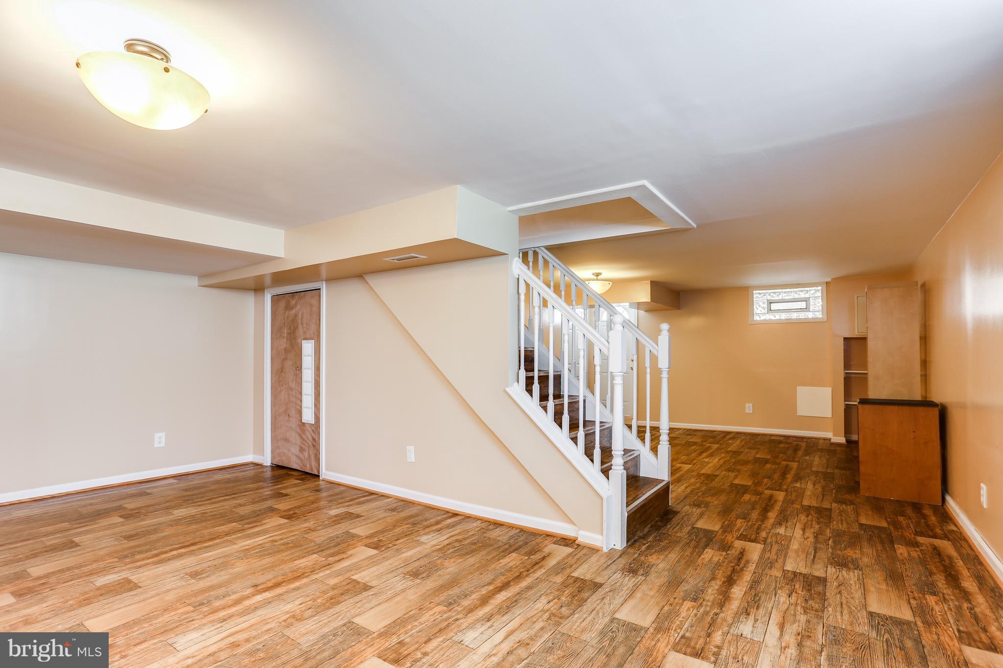 6117 Edlynne Road Baltimore, MD 21239 - Photo 18 of 18 a view of an entryway with wooden floor