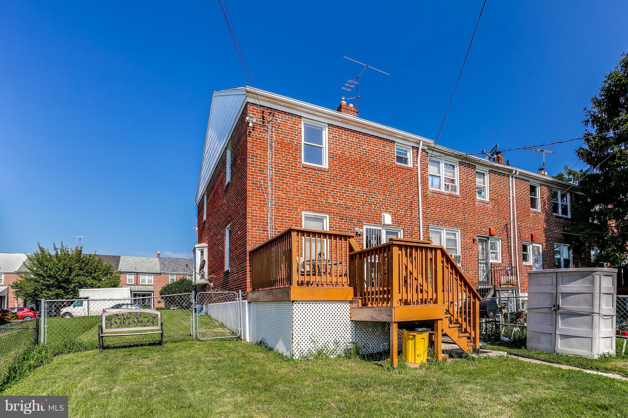 6117 Edlynne Road Baltimore, MD 21239 - Photo 5 of 18 a backyard of a house with table and chairs