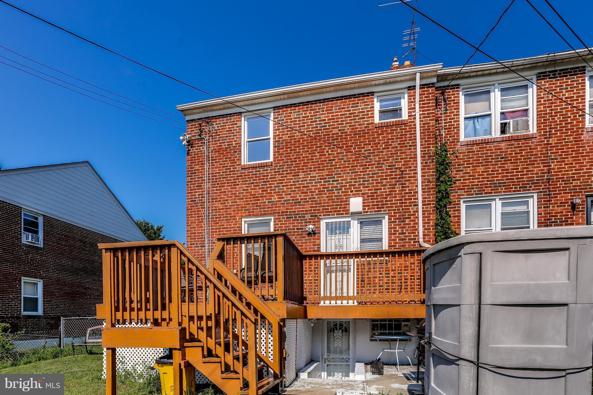 6117 Edlynne Road Baltimore, MD 21239 - Photo 6 of 18 a front view of a house with balcony and trees