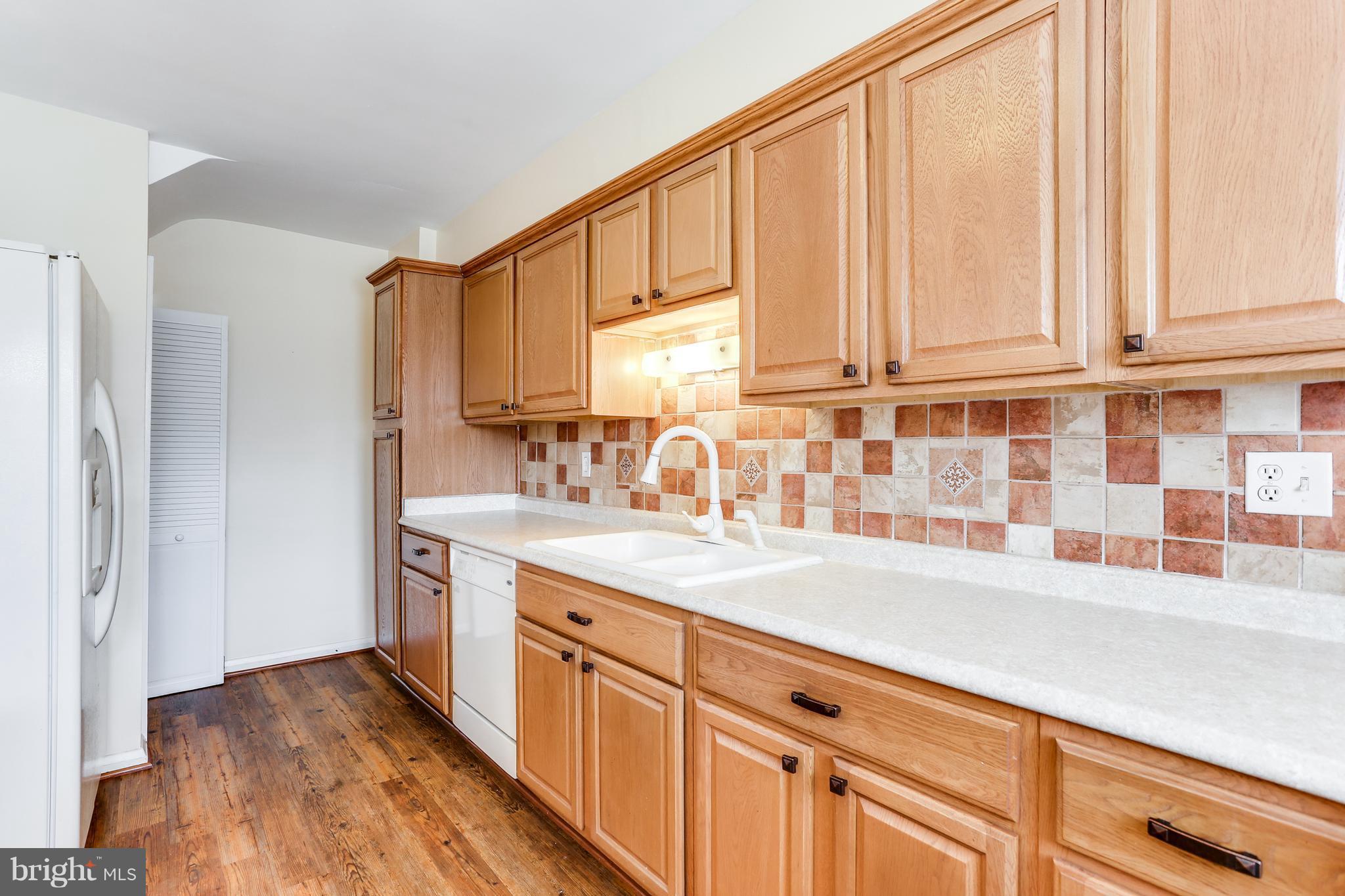 6117 Edlynne Road Baltimore, MD 21239 - Photo 9 of 18 a kitchen with a sink and cabinets