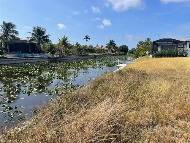 a view of a lake with a house in the background