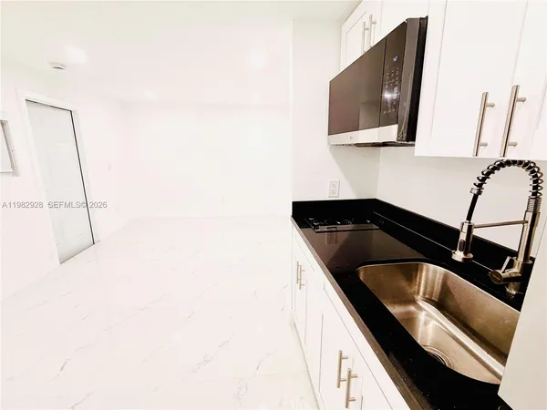 a kitchen with a sink and cabinets