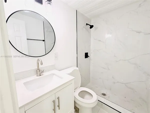 a bathroom with a sink toilet and shower