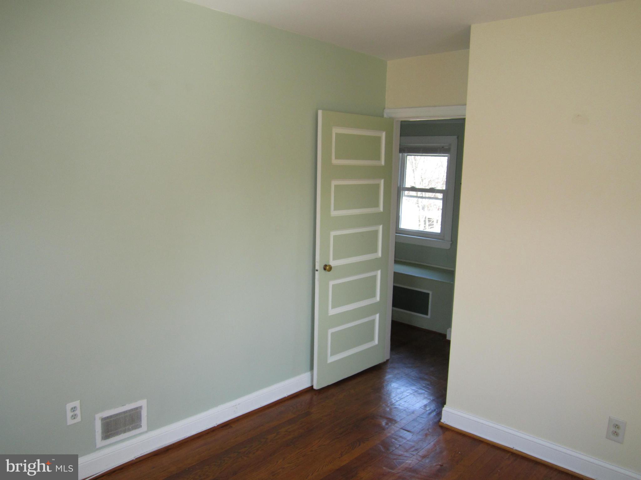 10017 Raynor Road Silver Spring, MD 20901 - Photo 14 of 29 an empty room with wooden floor closet and windows