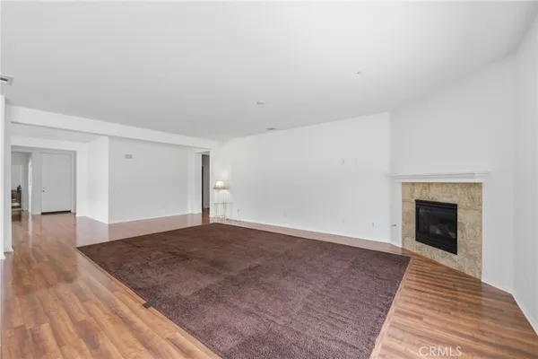 a view of an empty room and wooden floor