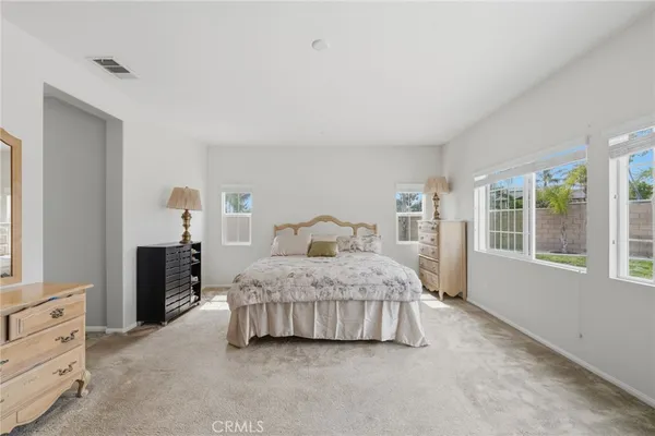 a spacious bedroom with a bed and window