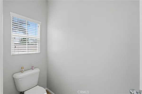 a white toilet sitting next to a window