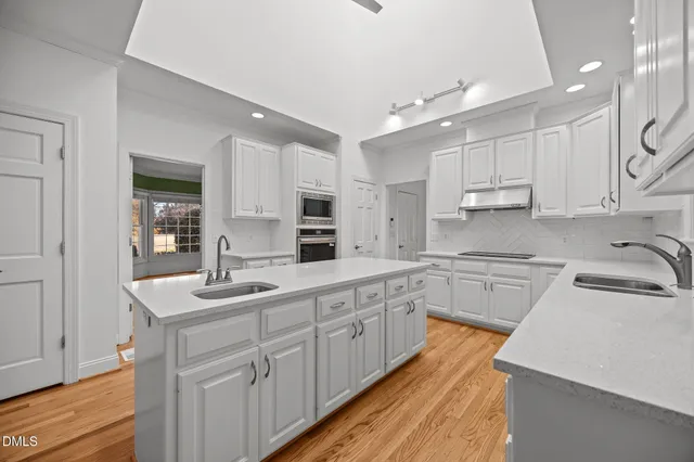 a bathroom with a sink a toilet a large mirror and shower