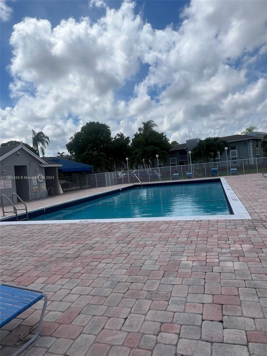 435 Northeast 210th Cir Terrace, Unit 10323 Miami, FL 33179 - Photo 15 of 15 a view of swimming pool with a yard in the background