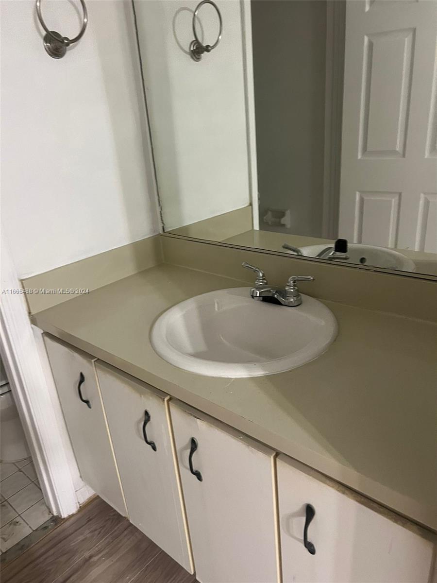 435 Northeast 210th Cir Terrace, Unit 10323 Miami, FL 33179 - Photo 8 of 15 a bathroom with a sink and a mirror
