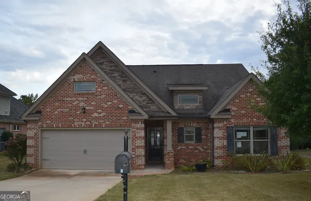 a front view of a house with garden