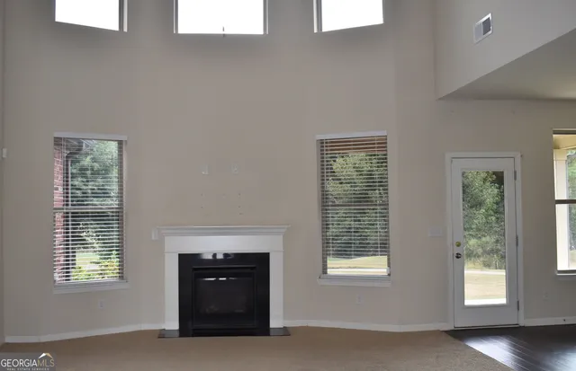 an empty room with windows and closet