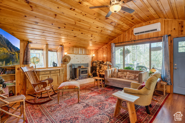 714 Spotted Fawn Way Kamas, UT 84036 - Photo 6 of 34 Living area with wood finished floors, healthy amount of natural light, lofted ceiling, wood walls, and wooden ceiling