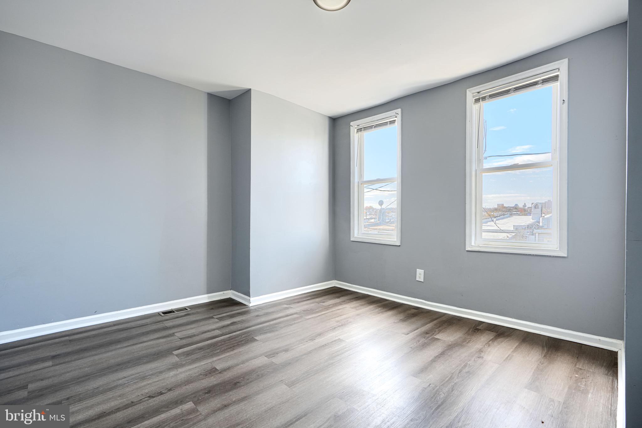 424 North Linwood Avenue Baltimore, MD 21224 - Photo 12 of 28 a view of a room with wooden floor and windows in it