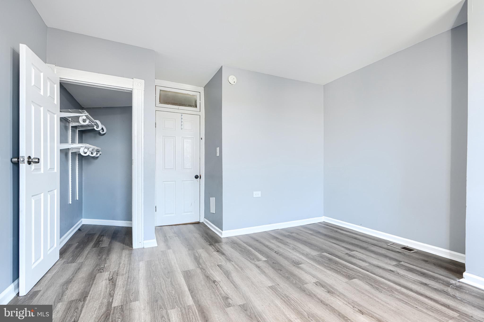 424 North Linwood Avenue Baltimore, MD 21224 - Photo 13 of 28 a view of a room with wooden floor and a bathroom
