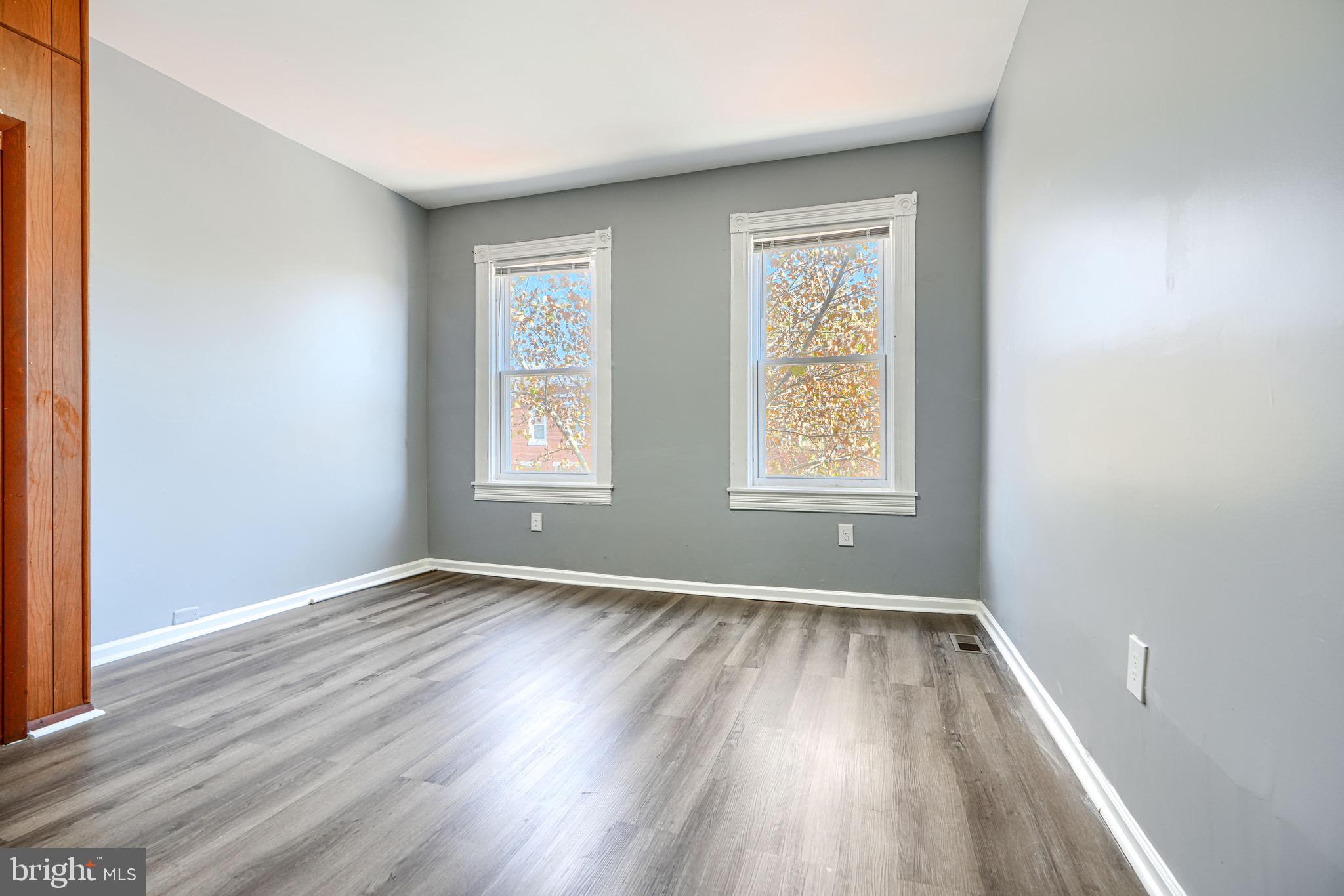 424 North Linwood Avenue Baltimore, MD 21224 - Photo 16 of 28 an empty room with wooden floor and windows