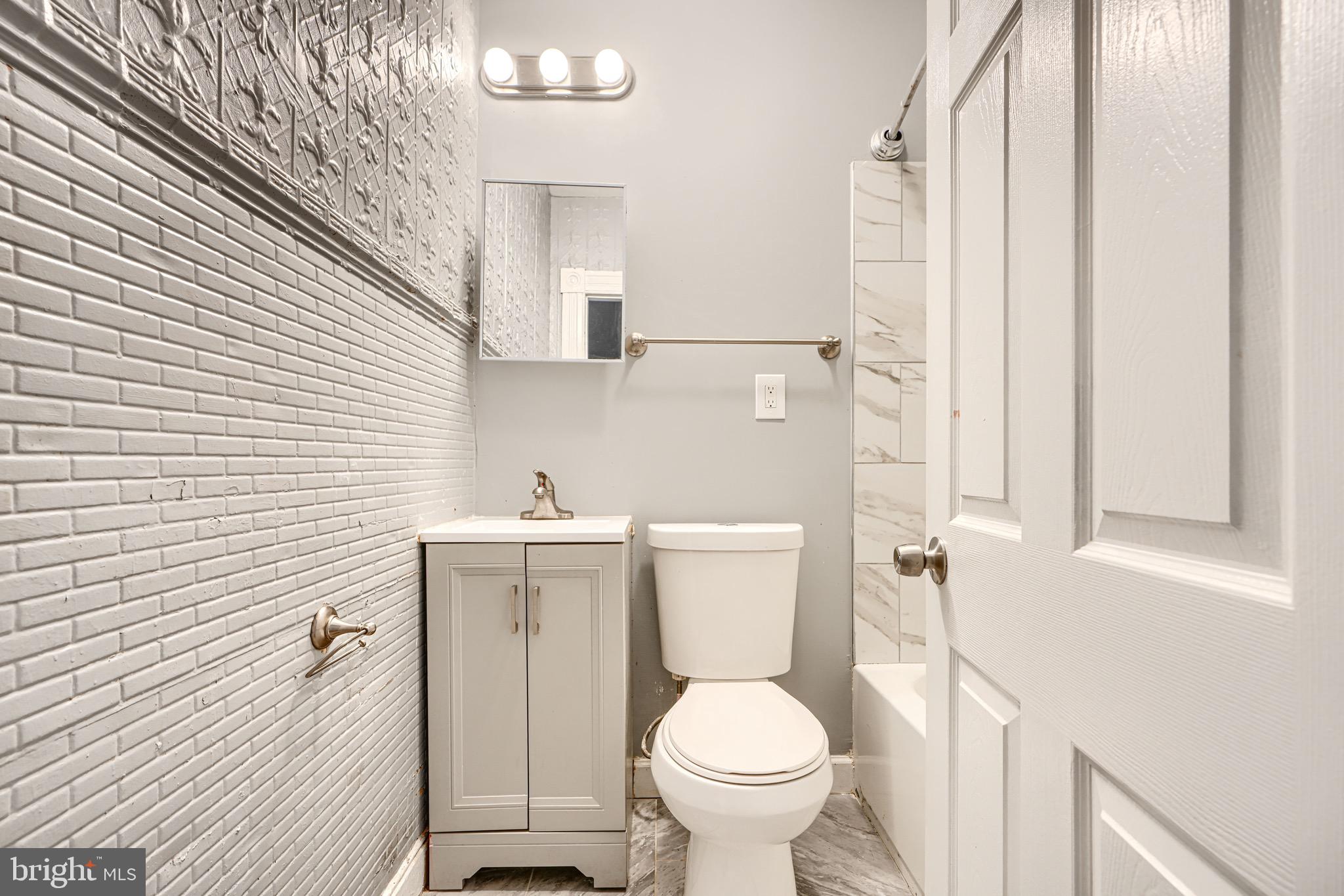 424 North Linwood Avenue Baltimore, MD 21224 - Photo 18 of 28 a bathroom with a sink toilet and shower