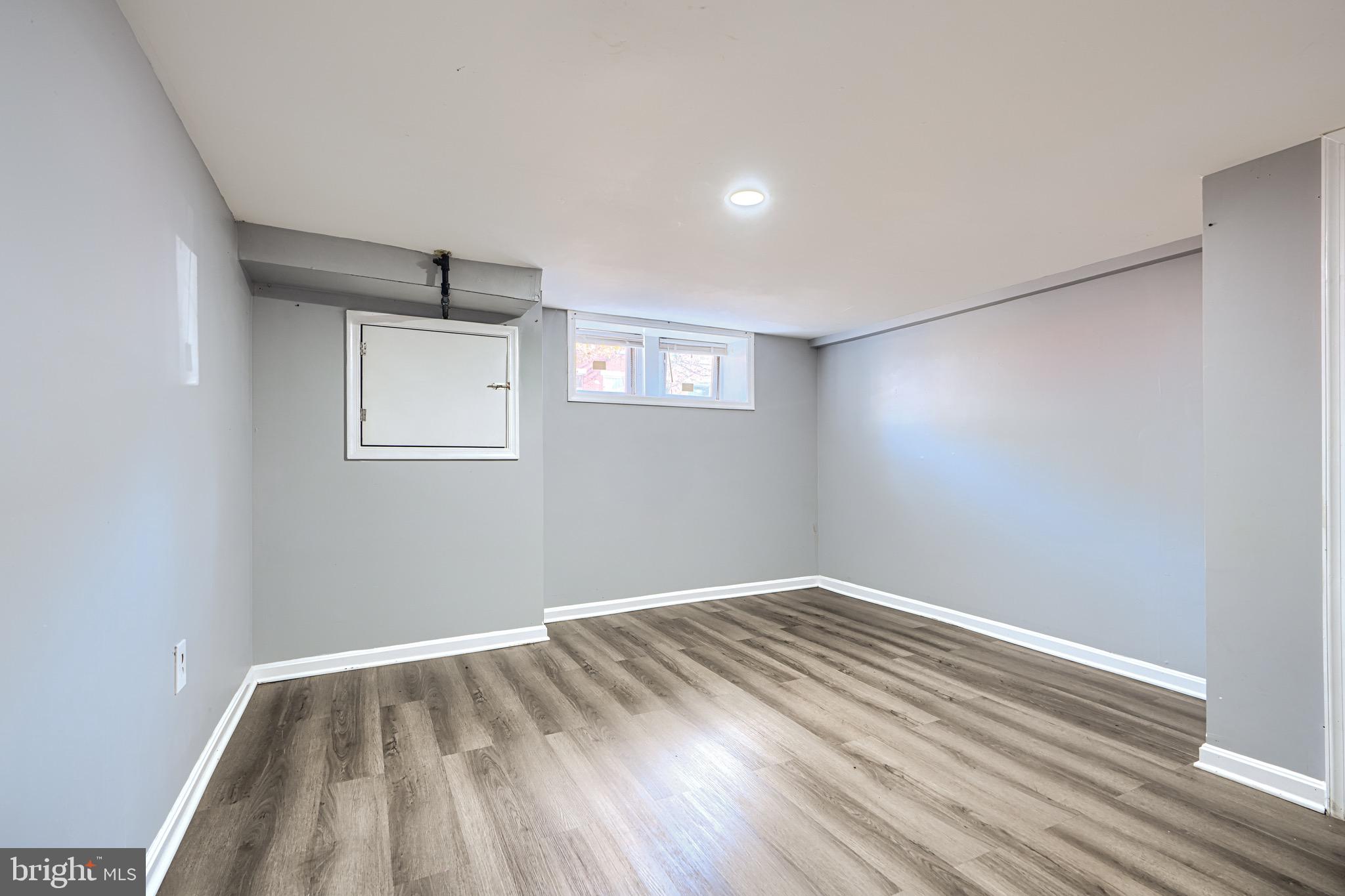 424 North Linwood Avenue Baltimore, MD 21224 - Photo 20 of 28 a view of room with wooden floor and window
