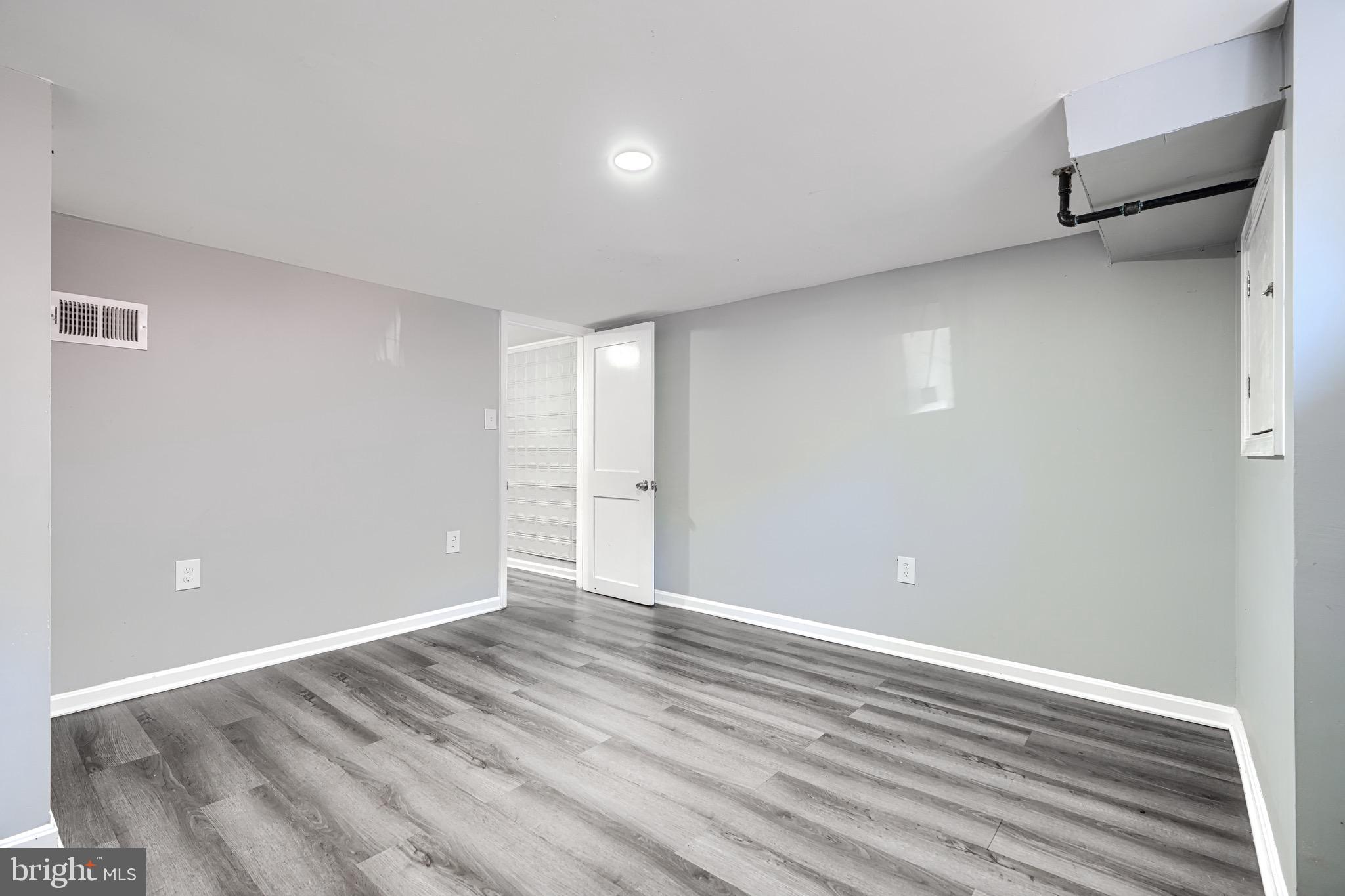 424 North Linwood Avenue Baltimore, MD 21224 - Photo 21 of 28 a view of an empty room with wooden floor