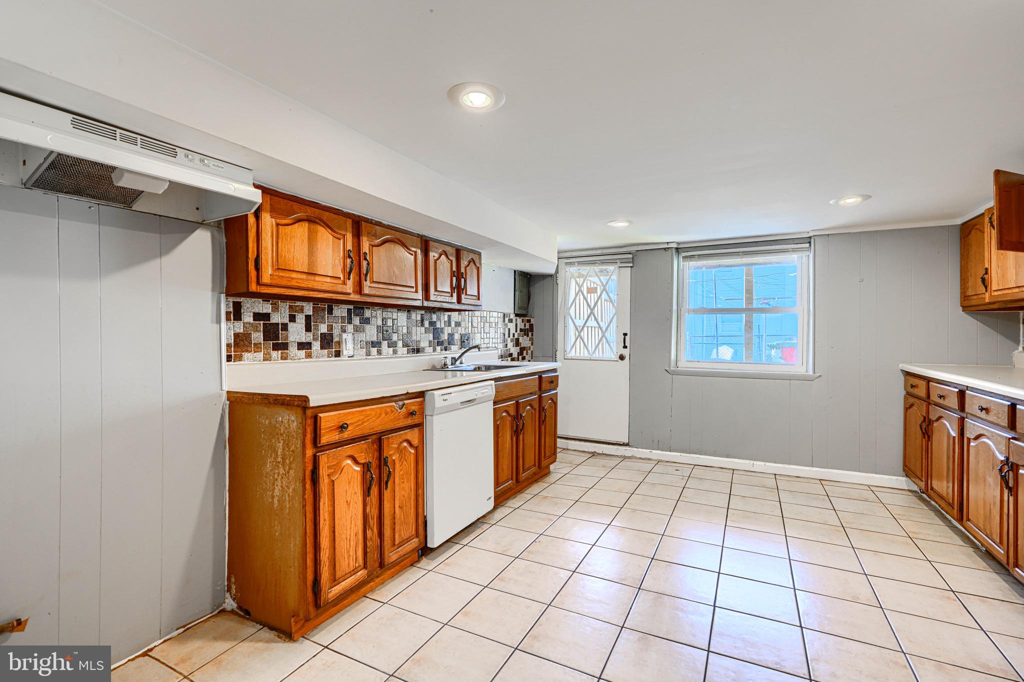 424 North Linwood Avenue Baltimore, MD 21224 - Photo 25 of 28 a kitchen with stainless steel appliances granite countertop a stove a sink and a refrigerator