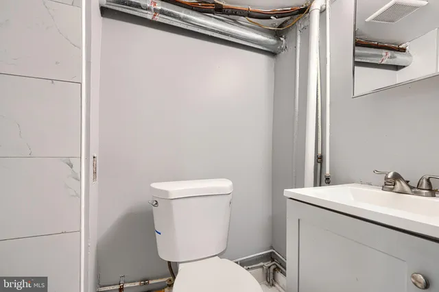 a white toilet sitting next to a bathroom sink