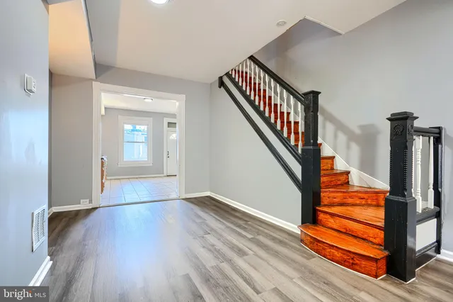 a view of entryway and hall with wooden floor