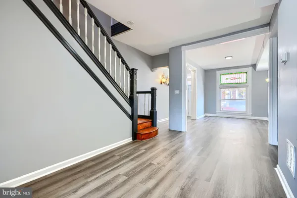 a view of an entryway with wooden floor and stairs