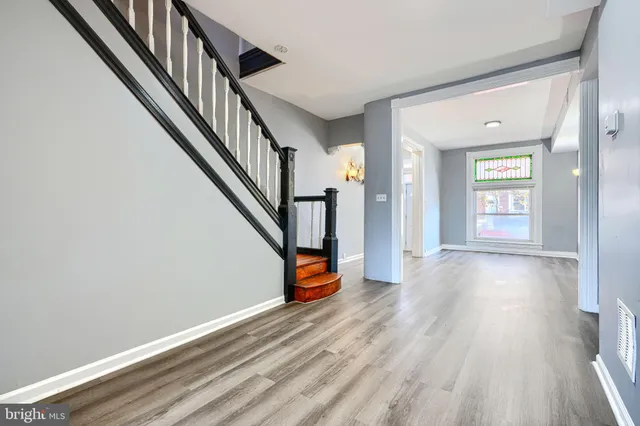 a view of an entryway with wooden floor and stairs