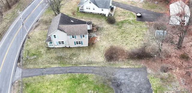 a view of a backyard with large trees