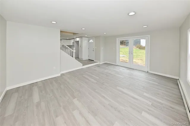a kitchen with a dining table chairs and refrigerator