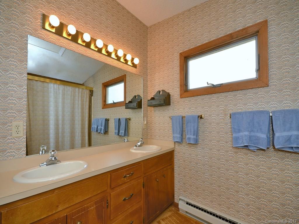 600 Brandywine Road, Unit 8 Waynesville, NC 28786 - Photo 12 of 18 a bathroom with a double vanity sink and a mirror