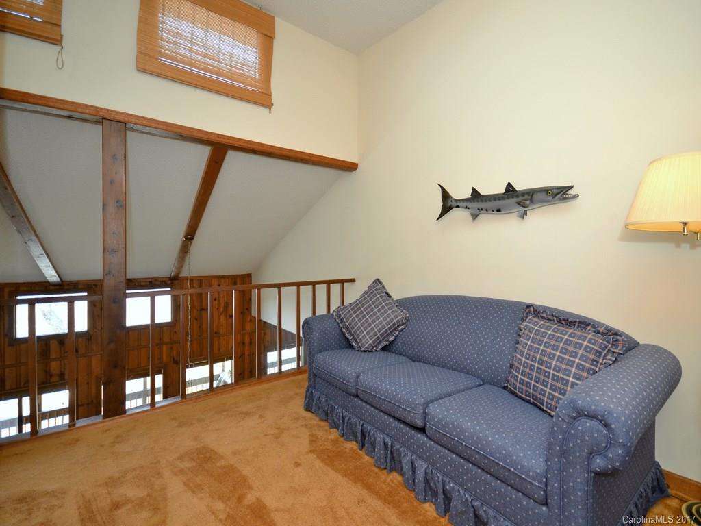 600 Brandywine Road, Unit 8 Waynesville, NC 28786 - Photo 13 of 18 a living room with furniture and a floor to ceiling window