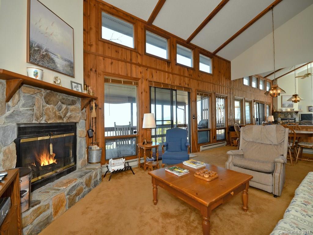 600 Brandywine Road, Unit 8 Waynesville, NC 28786 - Photo 3 of 18 a living room with furniture a fireplace and a floor to ceiling window