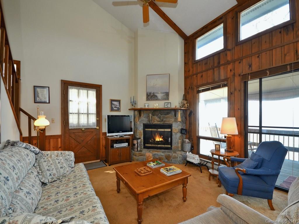 600 Brandywine Road, Unit 8 Waynesville, NC 28786 - Photo 4 of 18 a living room with furniture a flat screen tv and a fireplace