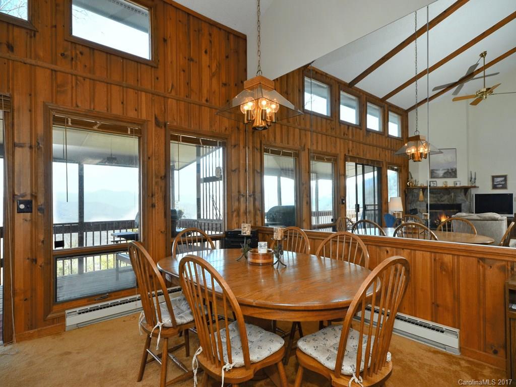 600 Brandywine Road, Unit 8 Waynesville, NC 28786 - Photo 5 of 18 a dining room with furniture a chandelier and fireplace