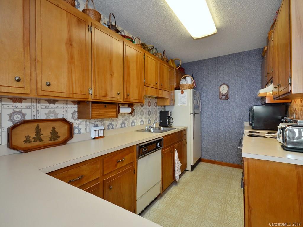 600 Brandywine Road, Unit 8 Waynesville, NC 28786 - Photo 6 of 18 a kitchen with stainless steel appliances granite countertop a sink a stove and a refrigerator