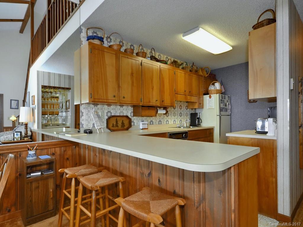 600 Brandywine Road, Unit 8 Waynesville, NC 28786 - Photo 8 of 18 a kitchen with a sink and cabinets