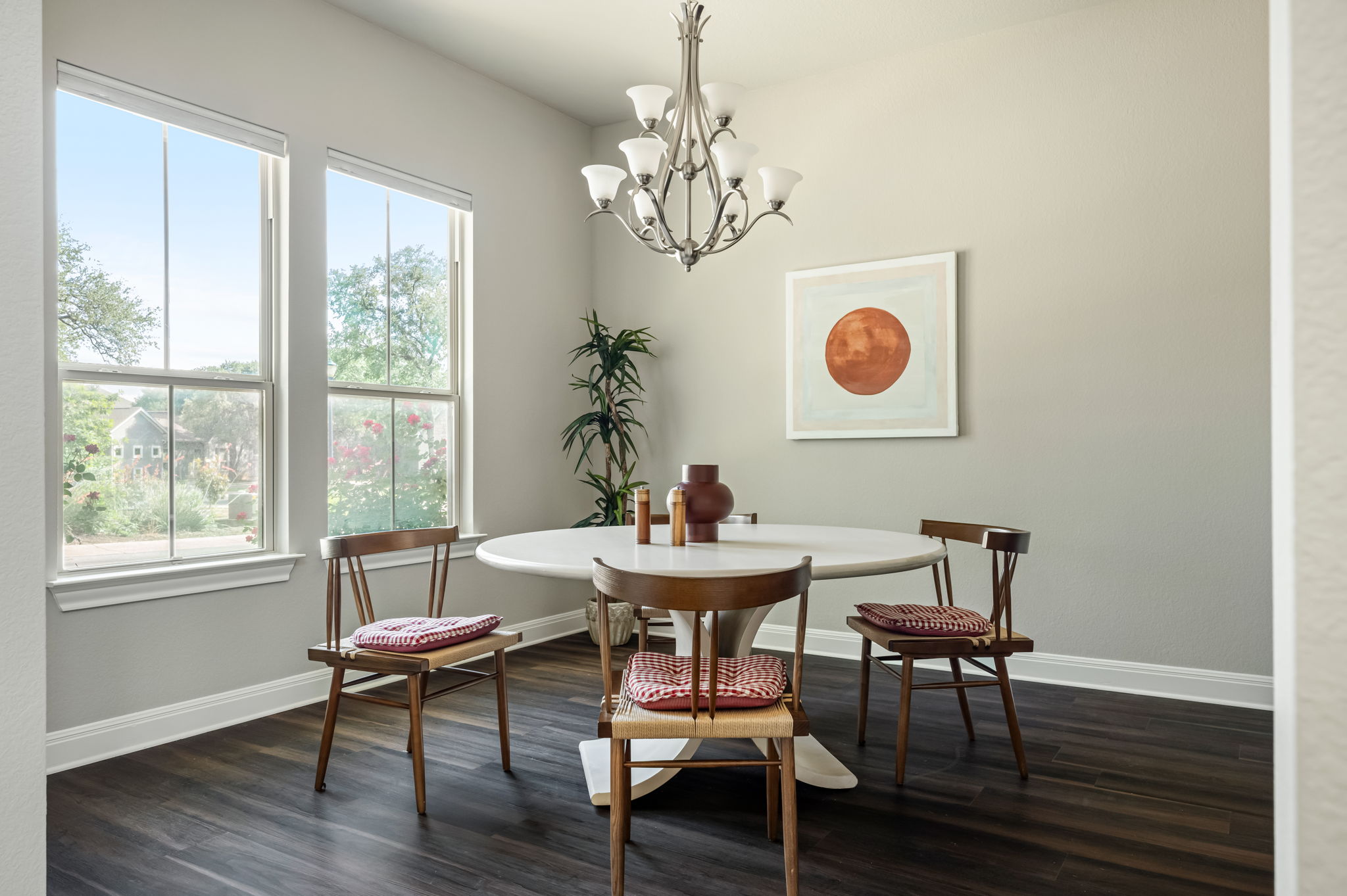2516 Hopsack Mills Road Austin, TX 78748 - Photo 8 of 39 Dining area featuring dark wood-finish flooring and two tall windows with white trim