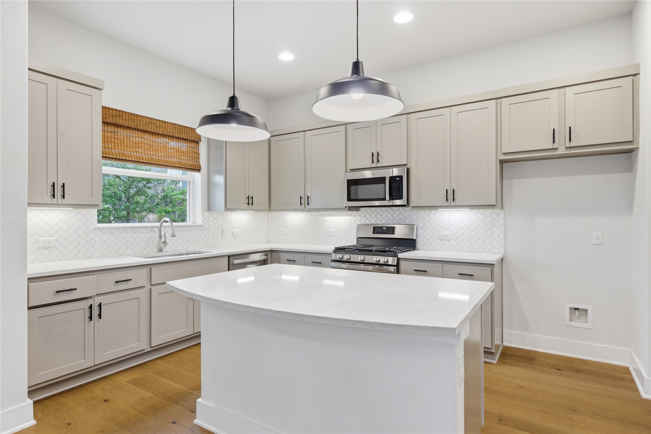 1300 Harwell Loop Kyle, TX 78640 - Photo 3 of 21 a kitchen with kitchen island white cabinets appliances and a window