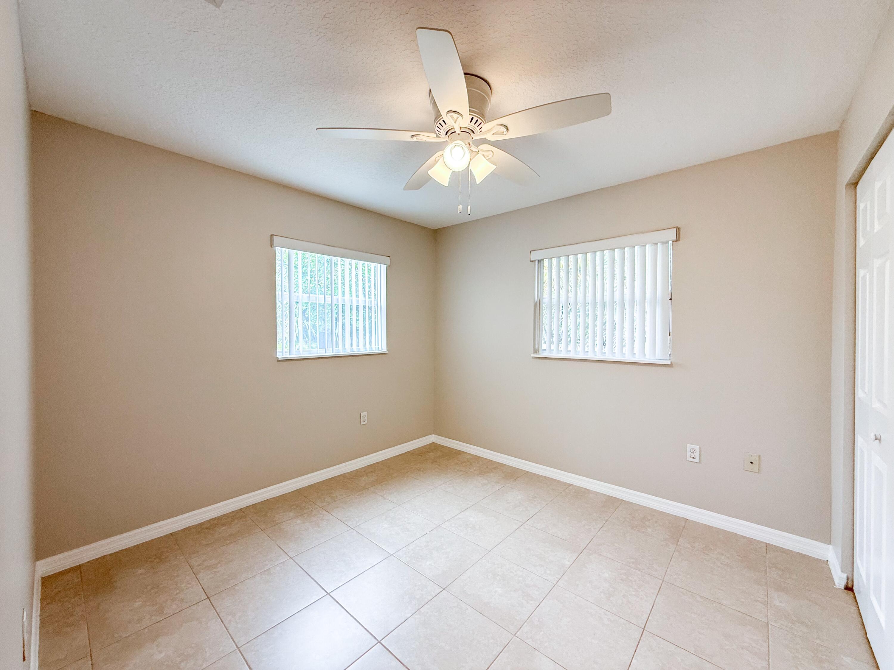 2719 Richard Road West Palm Beach, FL 33403 - Photo 9 of 14 an empty room with windows and fan