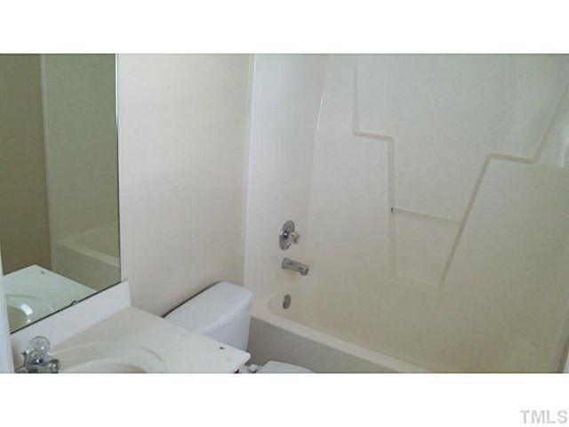 4900 Windsprint Way Raleigh, NC 27616 - Photo 11 of 16 a bathroom with a sink and a shower