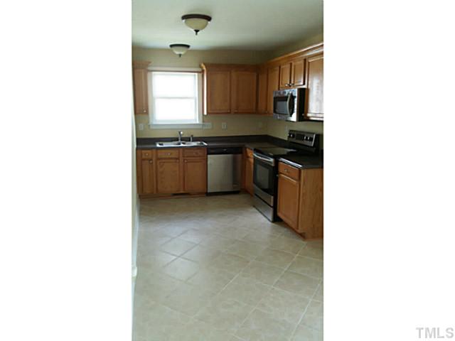 4900 Windsprint Way Raleigh, NC 27616 - Photo 2 of 16 a kitchen with granite countertop a sink cabinets and stainless steel appliances