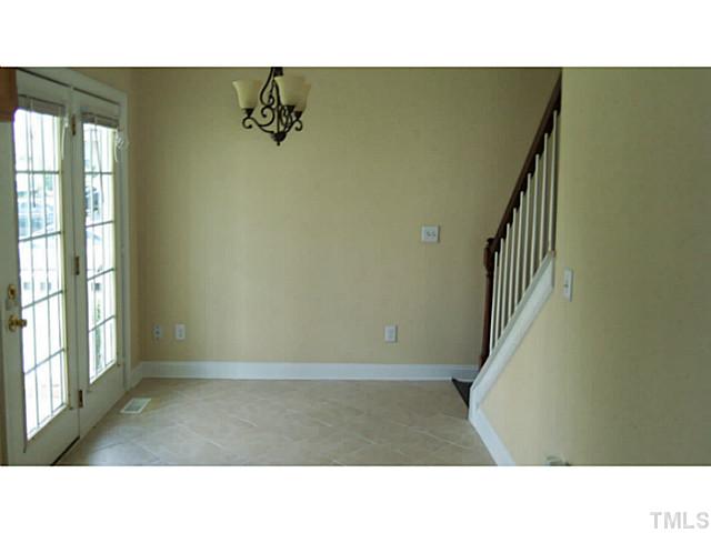 4900 Windsprint Way Raleigh, NC 27616 - Photo 3 of 16 a open living room with a window and stairs