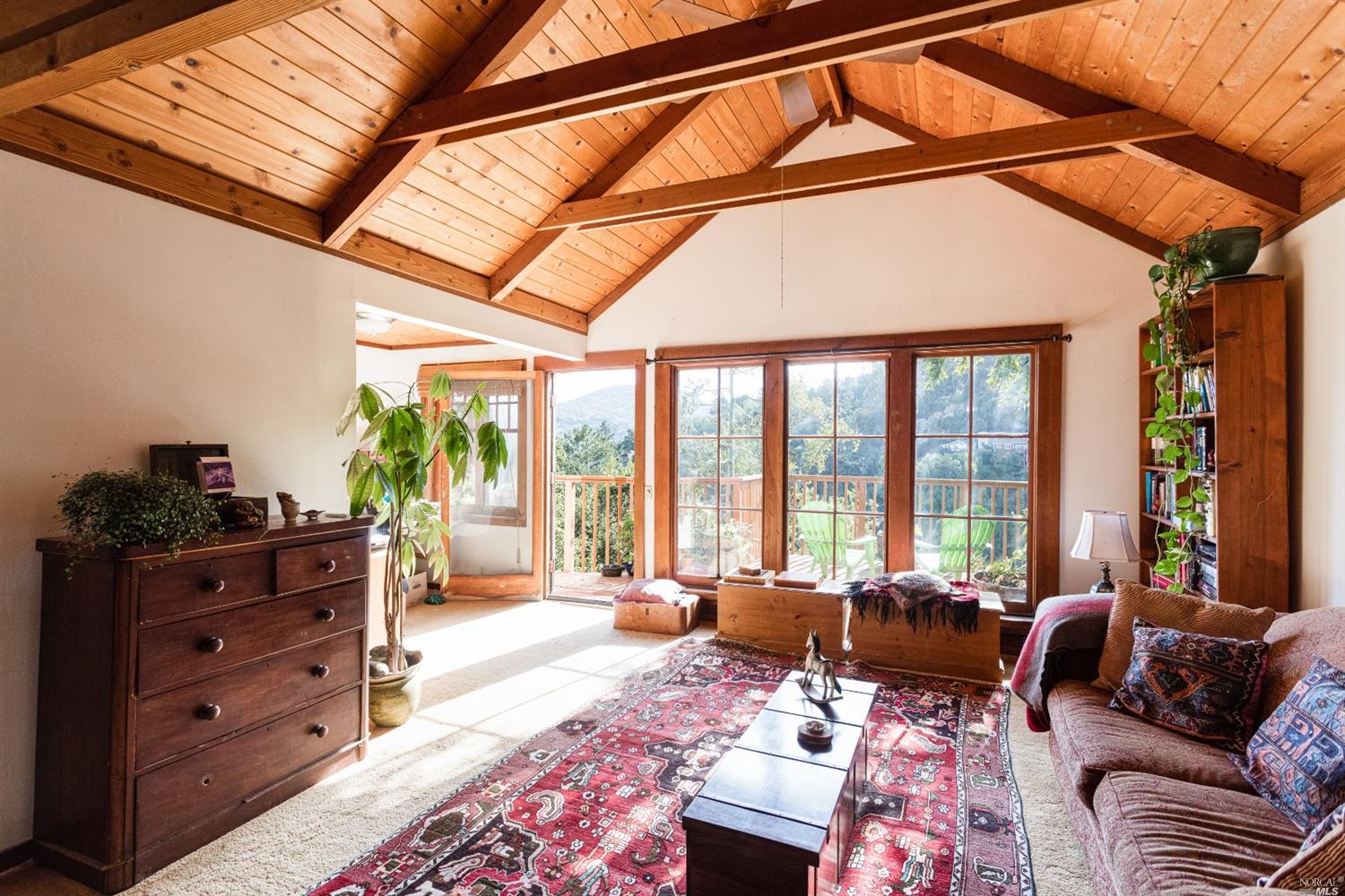 a living room with furniture windows and a flat screen tv