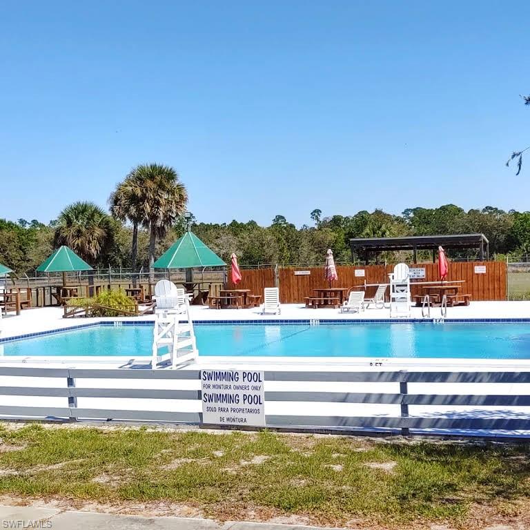 612 Hunting Clb Avenue Montura Ranches, FL 33440 - Photo 37 of 49 a view of swimming pool and lake view
