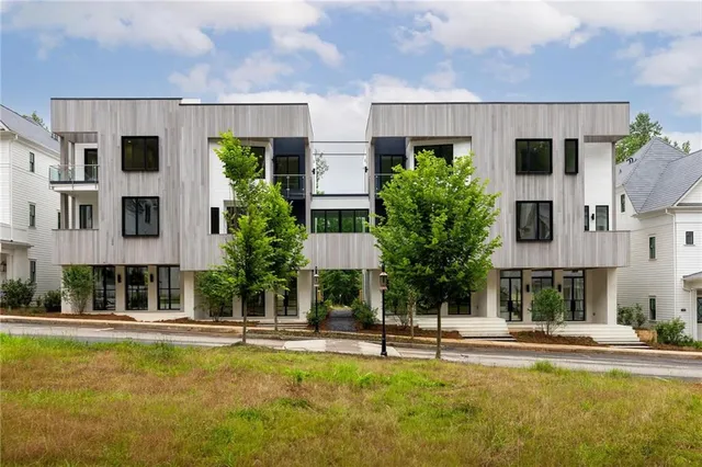 a view of house with swimming pool and outdoor seating