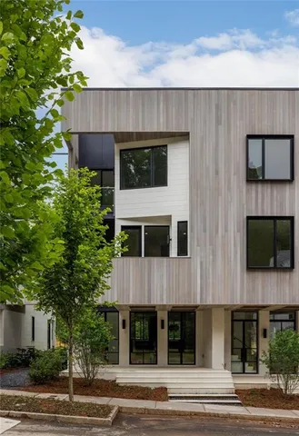 a view of a house with a yard and balcony
