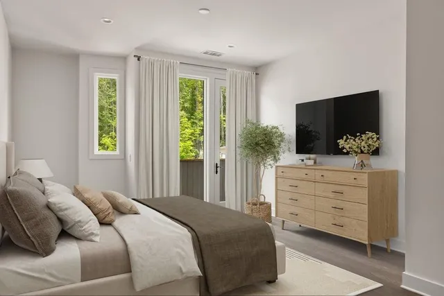 a bedroom with a bed and flat tv screen